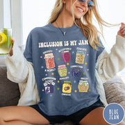 Comfort Colors tee in Blue Jean featuring retro style graphic with jam jars labeled with inclusion and advocacy terms