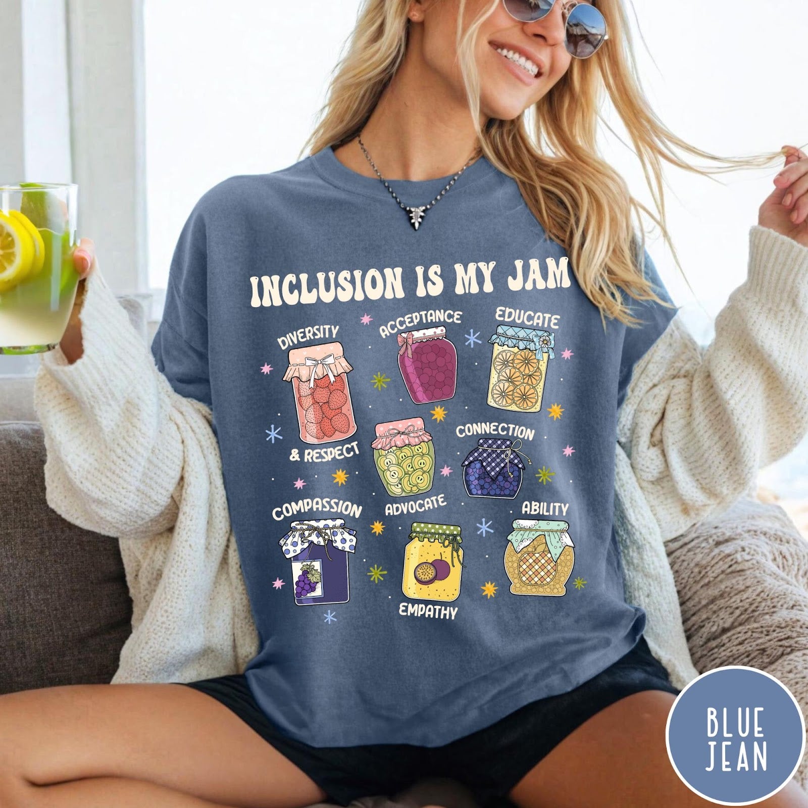 Comfort Colors tee in Blue Jean featuring retro style graphic with jam jars labeled with inclusion and advocacy terms