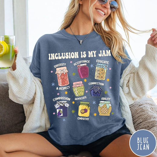 Comfort Colors tee in Blue Jean featuring retro style graphic with jam jars labeled with inclusion and advocacy terms