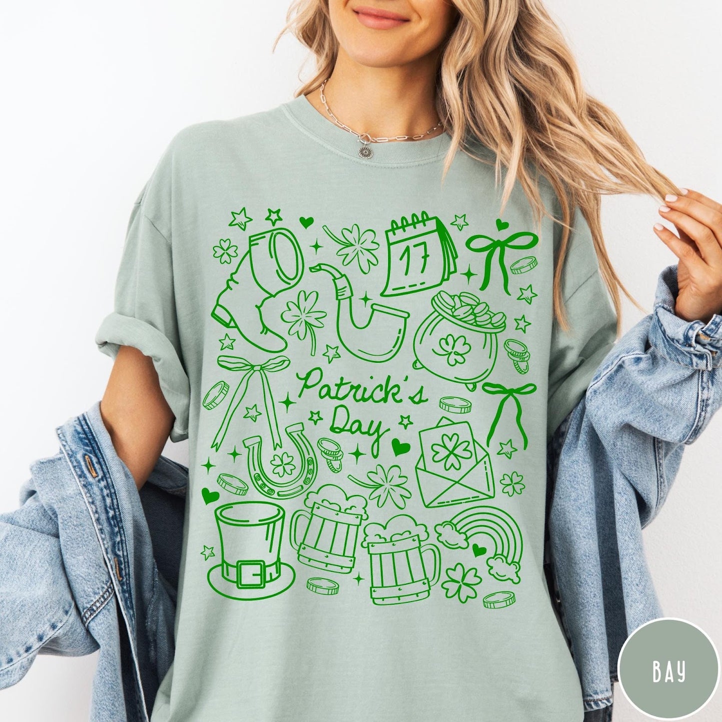 Comfort Colors tee in Bay featuring line art style St. Patrick's Day icons including shamrocks and leprechaun hat