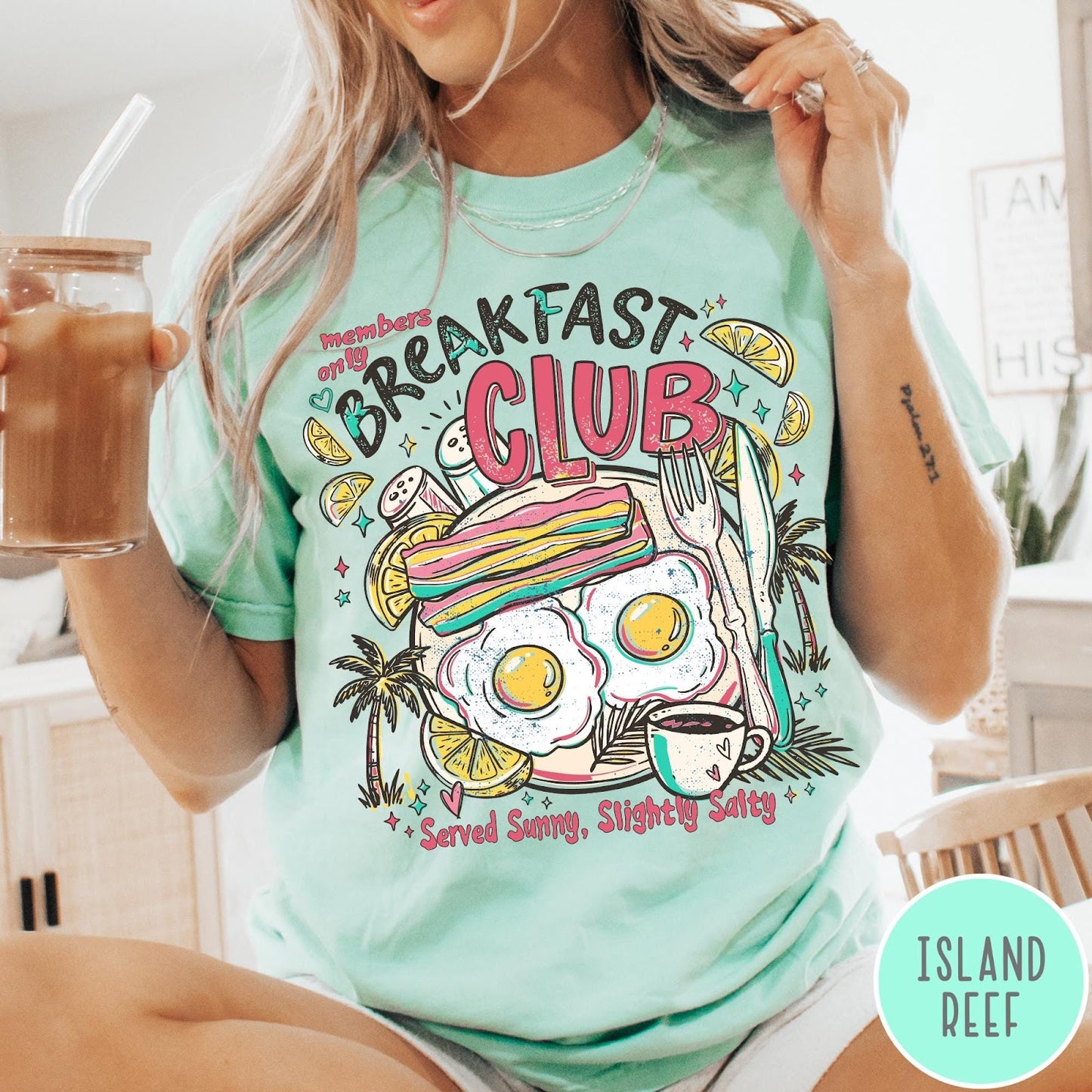 Comfort Colors tee in Island Reef featuring breakfast food graphic with bacon, eggs, coffee, and palm trees.