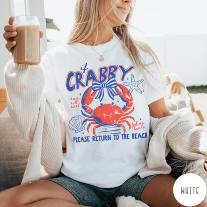 Comfort Colors tee in White featuring beachy crab graphic with bow, starfish, seashell, and coastal text