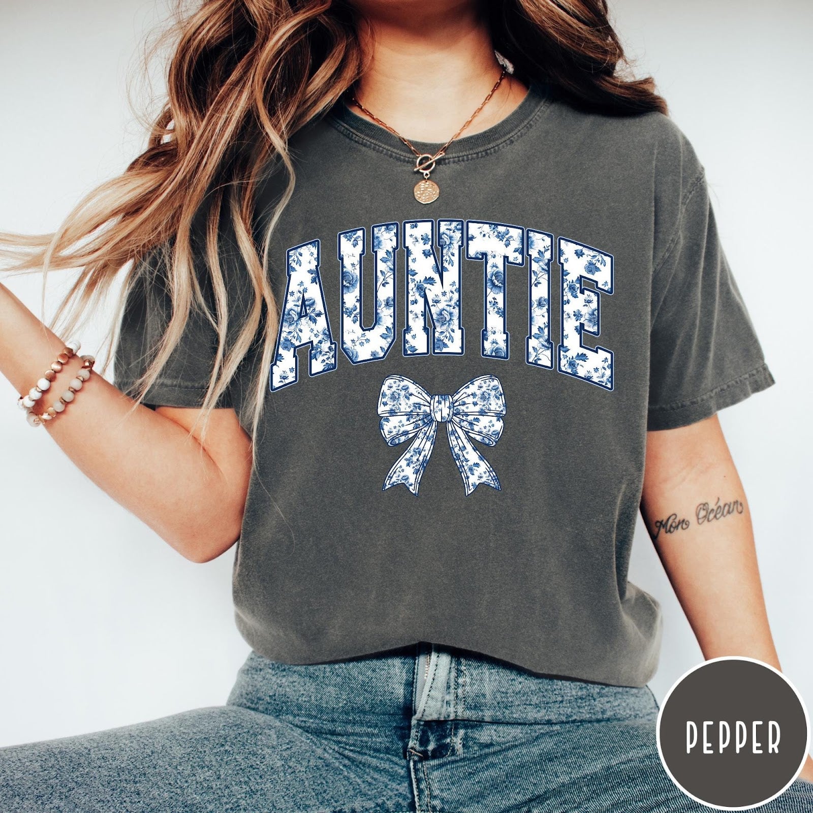 Comfort Colors tee in Pepper featuring floral bow graphic with the word Auntie in blue floral print