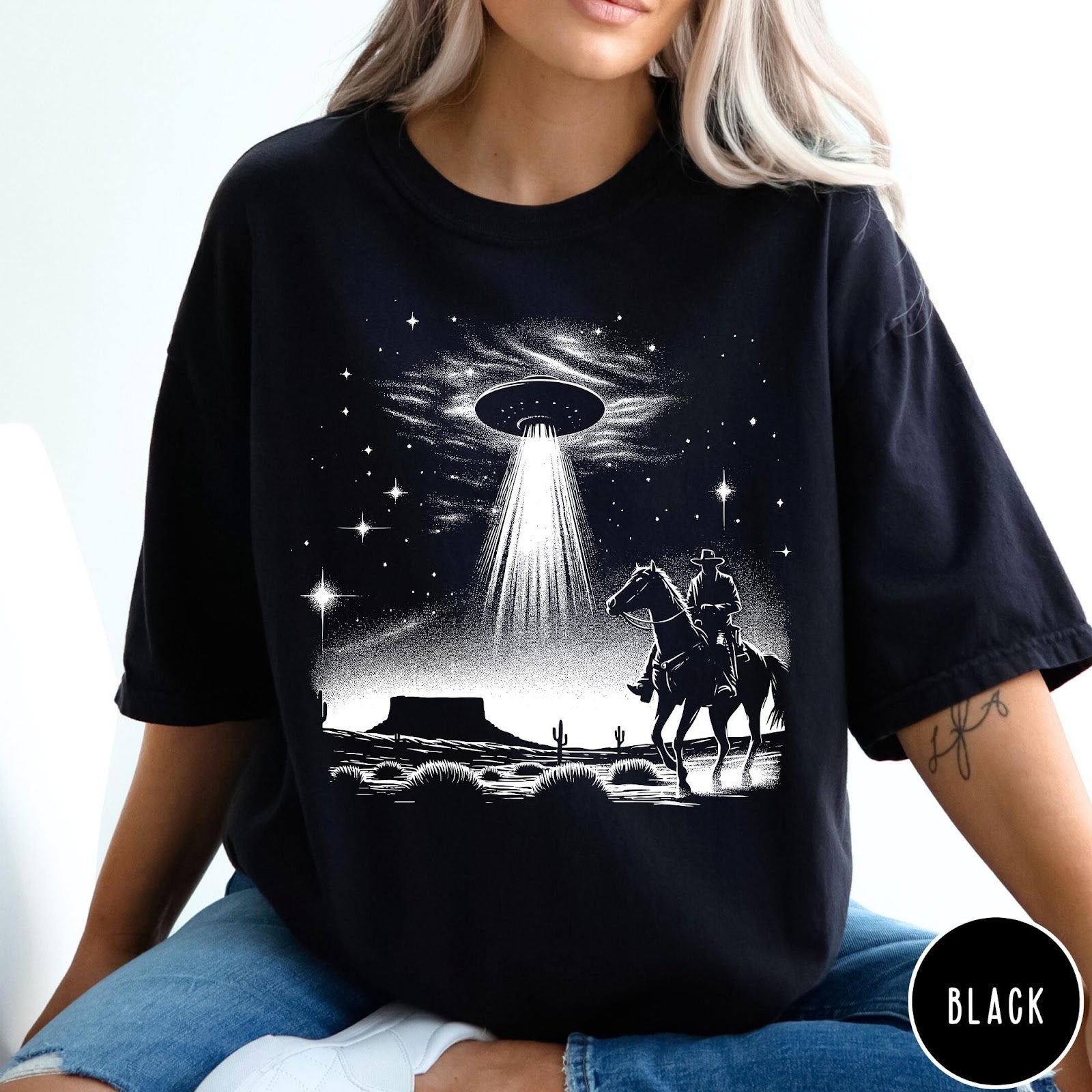 Comfort Colors tee in Black featuring western graphic style with a cowboy riding a horse under a UFO