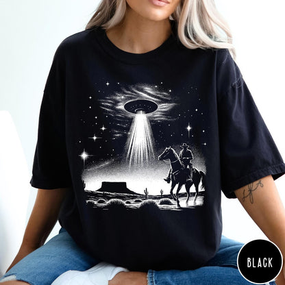 Comfort Colors tee in Black featuring western graphic style with a cowboy riding a horse under a UFO