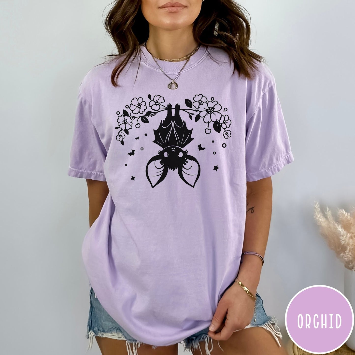 Comfort Colors tee in Orchid featuring line art style upside down bat graphic with surrounding floral elements
