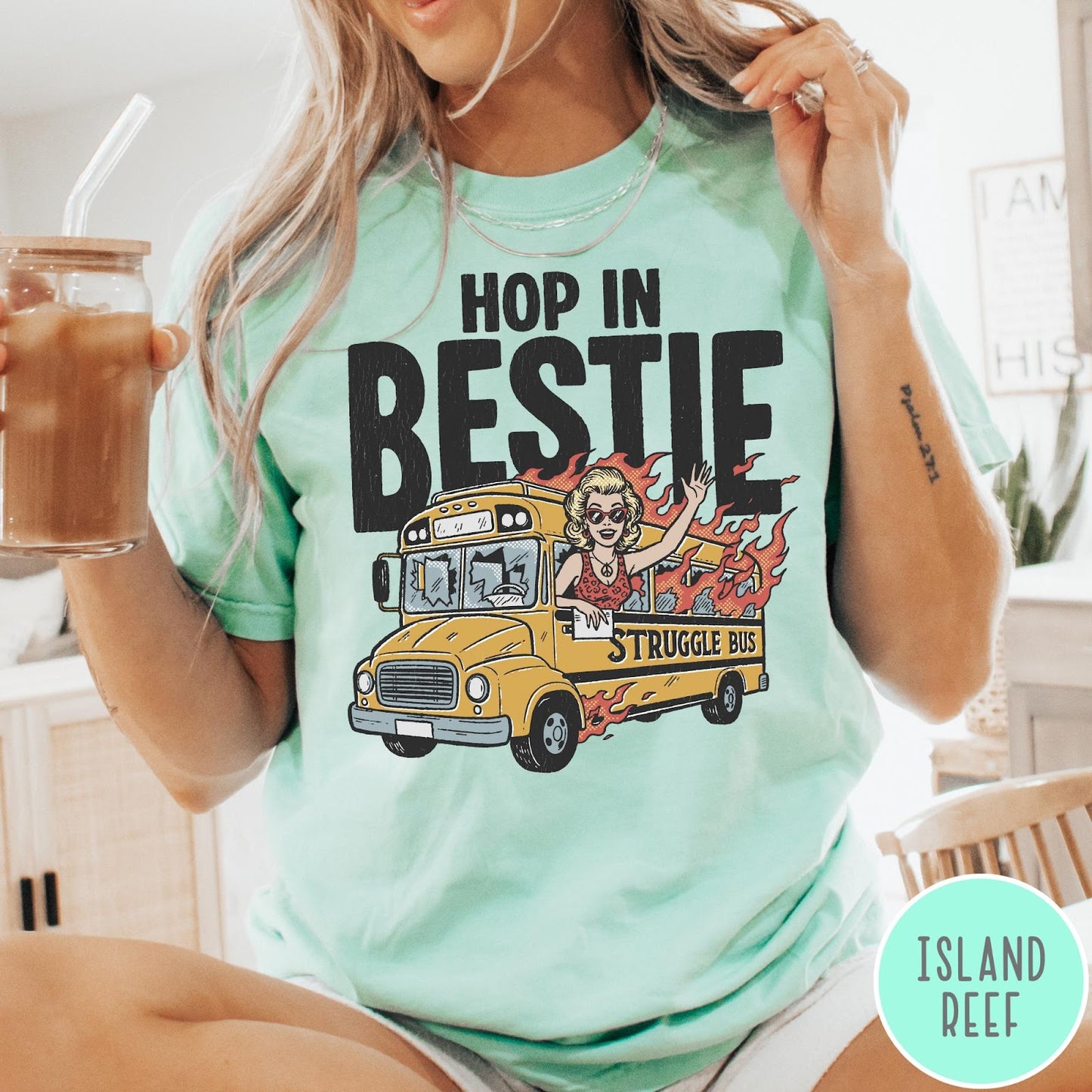 Comfort Colors tee in Island Reef featuring retro style graphic of a woman waving from a burning school bus