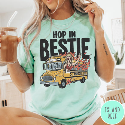 Comfort Colors tee in Island Reef featuring retro style graphic of a woman waving from a burning school bus