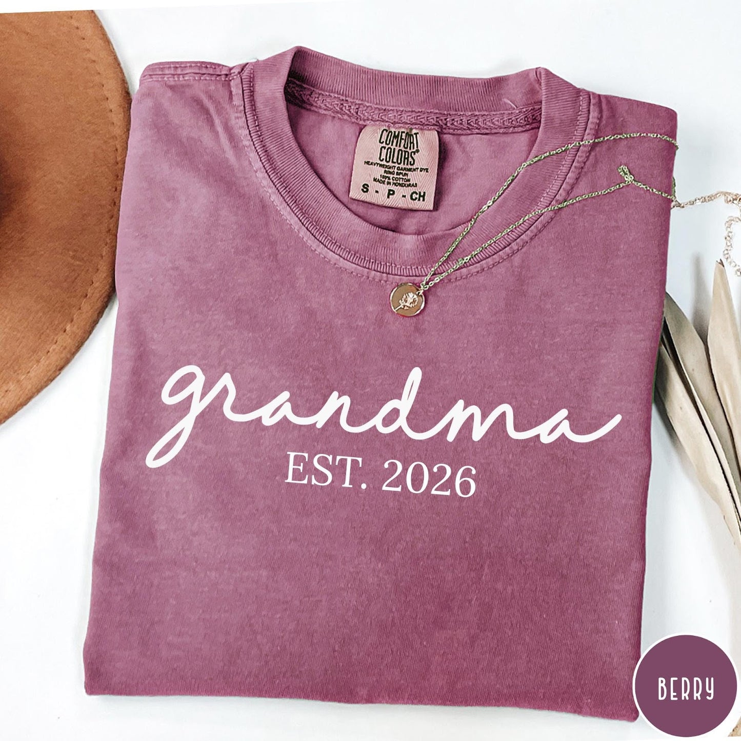 Comfort Colors tee in Berry featuring cursive Grandma Est 2026 text in a clean white graphic style