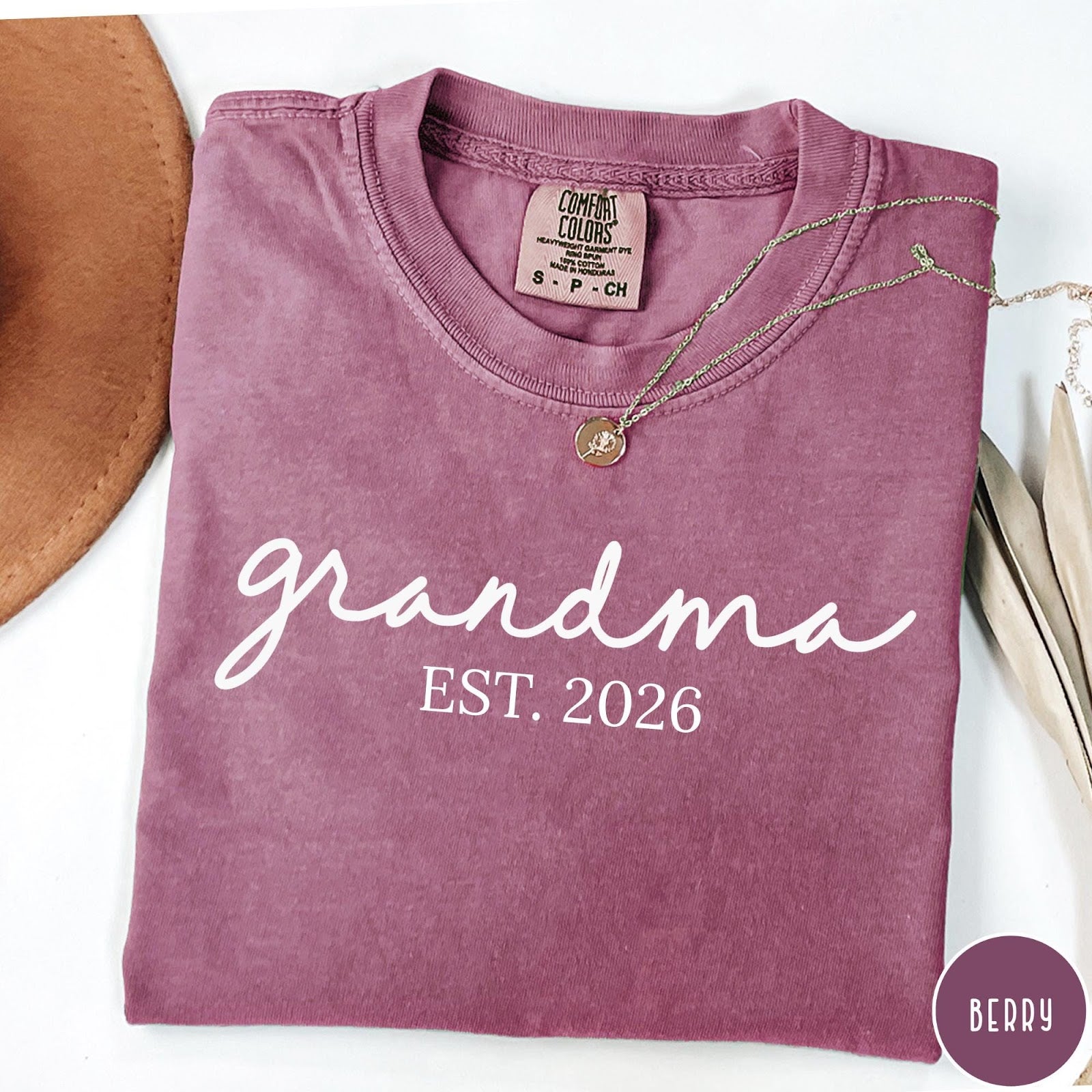 Comfort Colors tee in Berry featuring cursive Grandma Est 2026 text in a clean white graphic style
