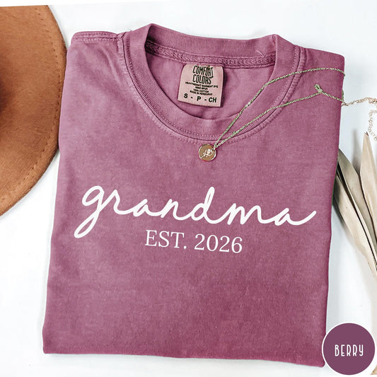 Comfort Colors tee in Berry featuring cursive Grandma Est 2026 text in a clean white graphic style