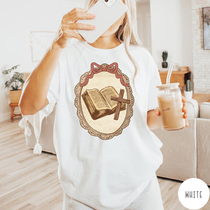 Comfort Colors tee in White featuring vintage style graphic of an open Bible and wooden Christian cross.