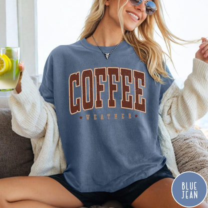 Comfort Colors tee in Blue Jean featuring collegiate style Coffee Weather graphic with distressed brown text and stars