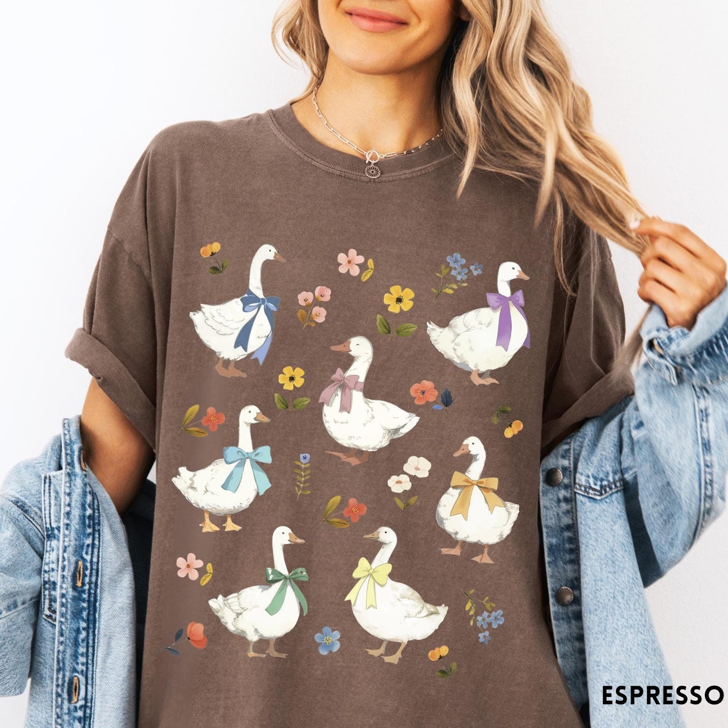 Comfort Colors tee in Espresso featuring vintage style graphic of several white geese wearing colorful bows and flowers