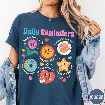 Comfort Colors tee in Midnight featuring retro mascot graphic with daily affirmations and cute cartoon characters