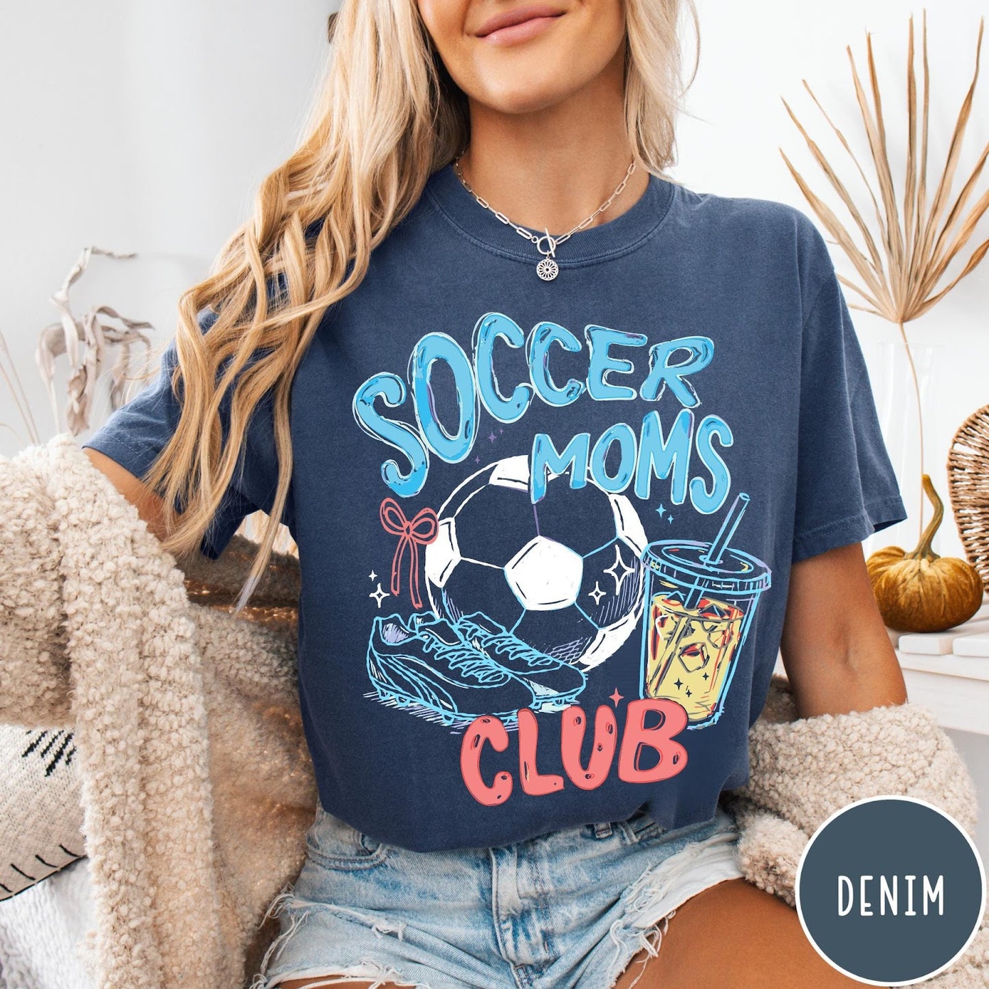 Comfort Colors tee in Denim featuring soccer mom lifestyle graphic with soccer ball, cleats, and iced coffee