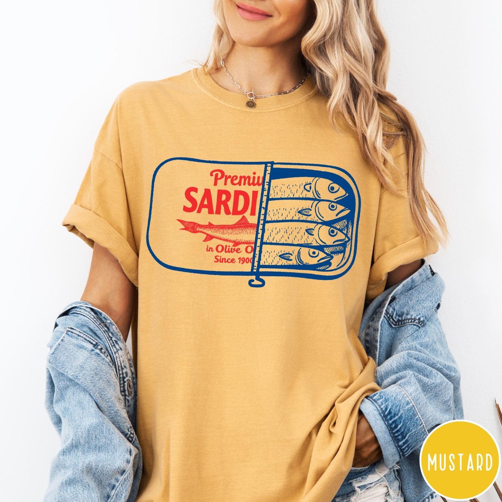 Comfort Colors tee in Mustard featuring vintage style sardine tin graphic with red text and blue fish