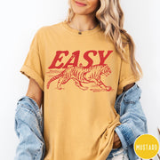 Comfort Colors tee in Mustard featuring vintage style graphic of a walking tiger and text Easy