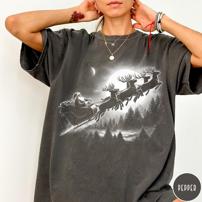 Comfort Colors tee in Pepper featuring vintage style Santa Claus flying in a sleigh with reindeer