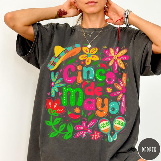 Comfort Colors tee in Pepper featuring festive Cinco de Mayo graphic with sombrero, maracas, and colorful flowers