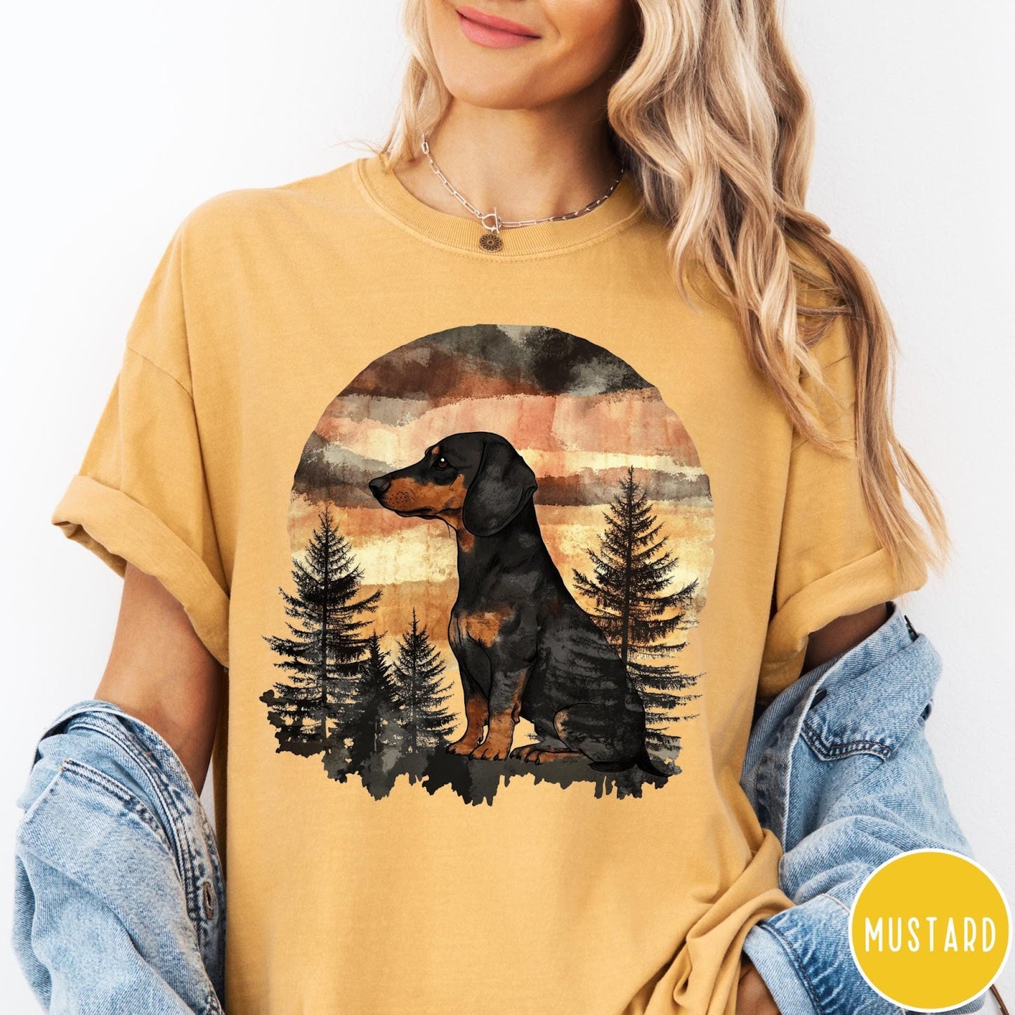 Comfort Colors tee in Mustard featuring vintage style graphic of a dachshund sitting in a forest sunset
