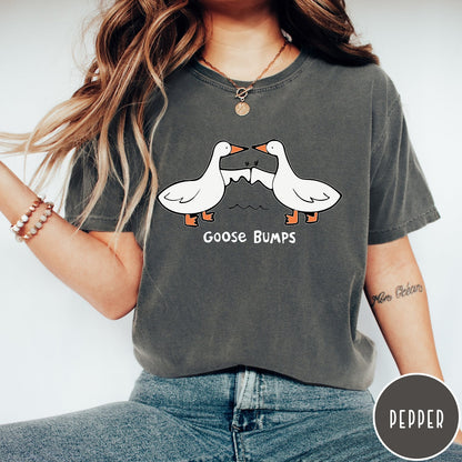 Comfort Colors tee in Pepper featuring cartoon style graphic of two geese giving each other a fist bump