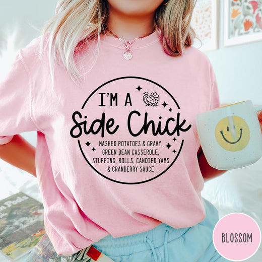 Comfort Colors tee in Blossom featuring circular Thanksgiving side dish graphic with turkey and food list