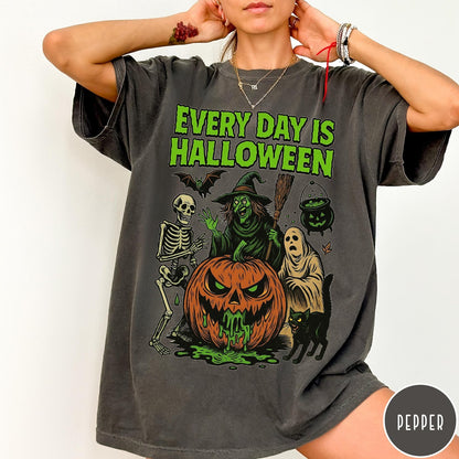 Comfort Colors tee in Pepper featuring Halloween graphic with a witch, skeleton, ghost, and a dripping pumpkin.
