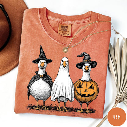 Comfort Colors tee in Yam featuring Halloween graphic with three geese dressed as a witch, ghost, and pumpkin