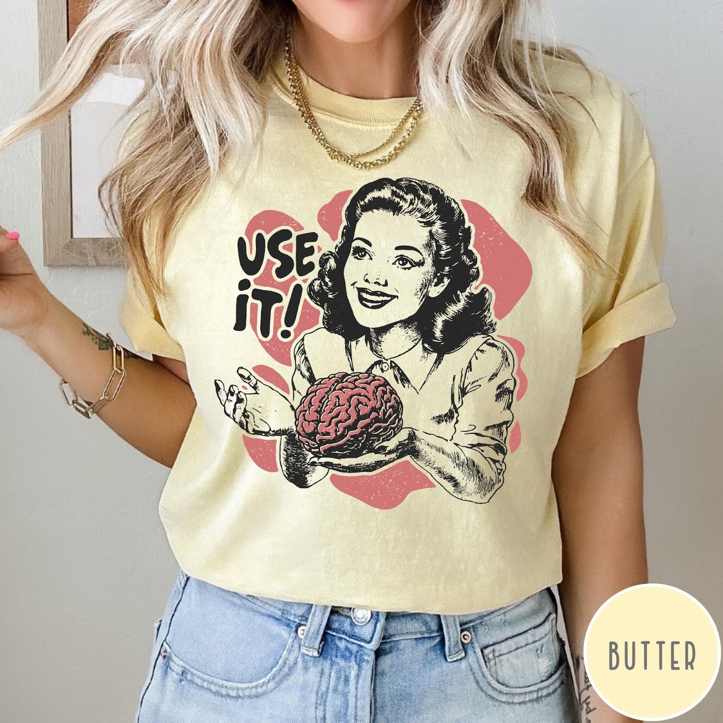 Comfort Colors tee in Butter featuring retro style graphic of a woman holding a human brain