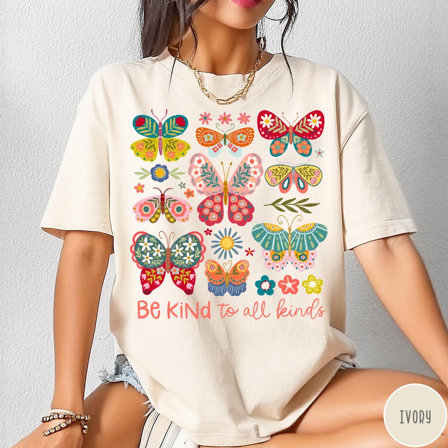 Comfort Colors tee in Ivory featuring butterfly and floral graphic design with Be Kind to all kinds text