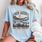 Comfort Colors tee in Chambray featuring desert landscape graphic with a rider and sun design.