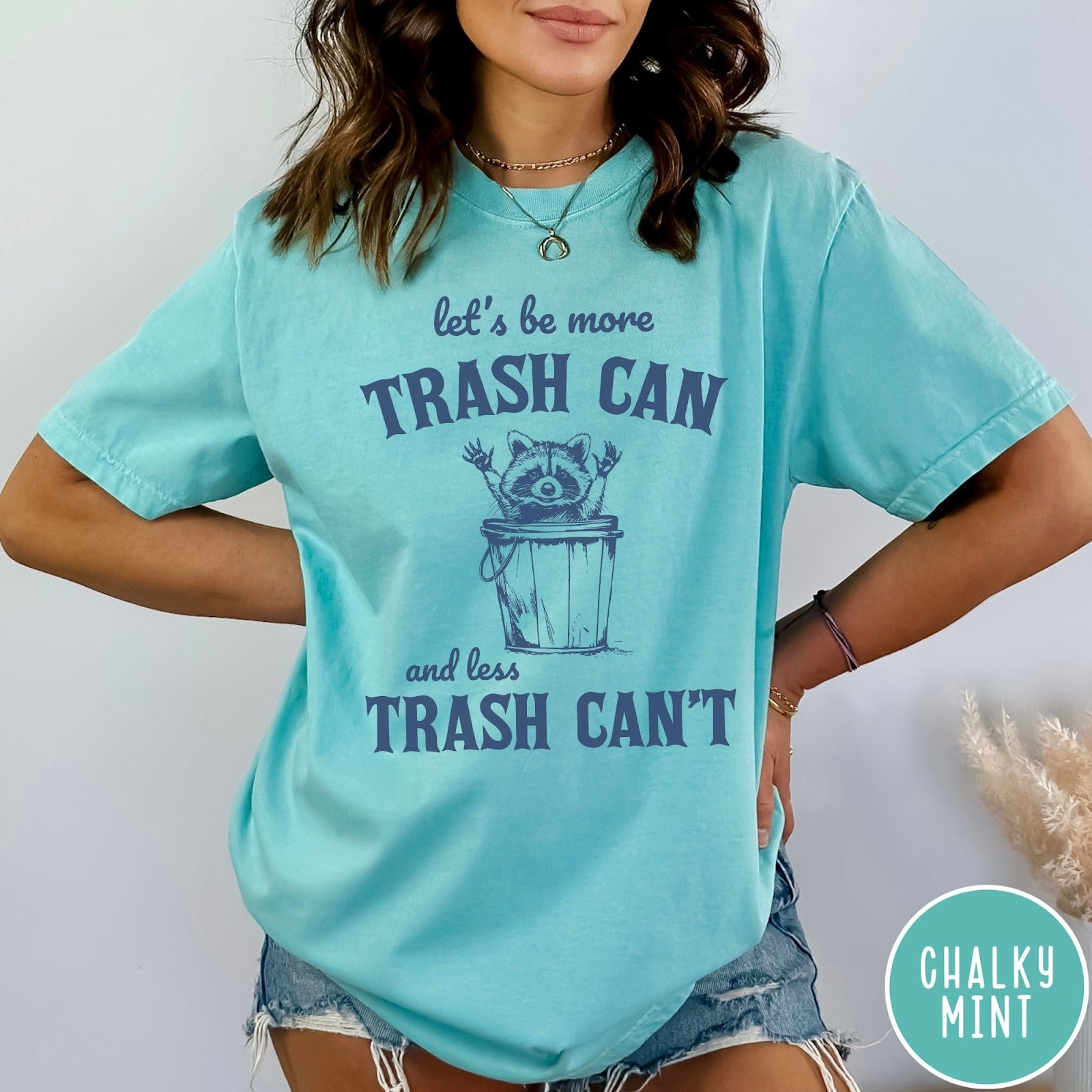 Comfort Colors tee in Chalky Mint featuring casual graphic style with a raccoon inside a trash can illustration