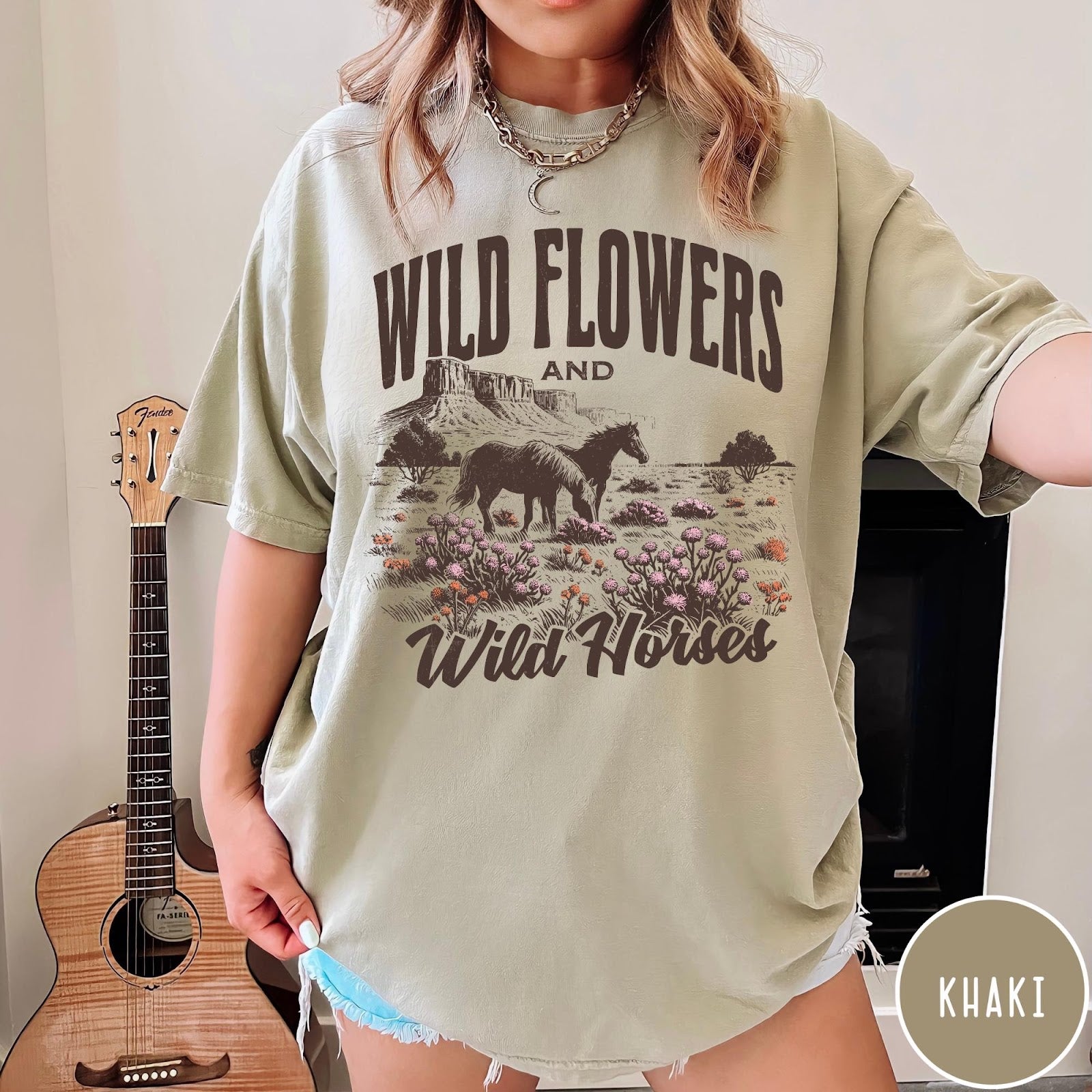 Comfort Colors tee in Khaki featuring western style graphic of wild horses grazing in a wildflower field