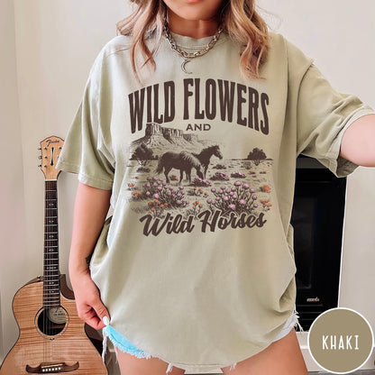 Comfort Colors tee in Khaki featuring western style graphic of wild horses grazing in a wildflower field