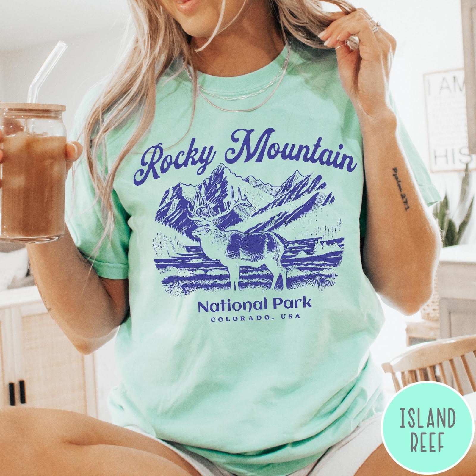 Comfort Colors tee in Island Reef featuring vintage style graphic of an elk standing in front of mountains