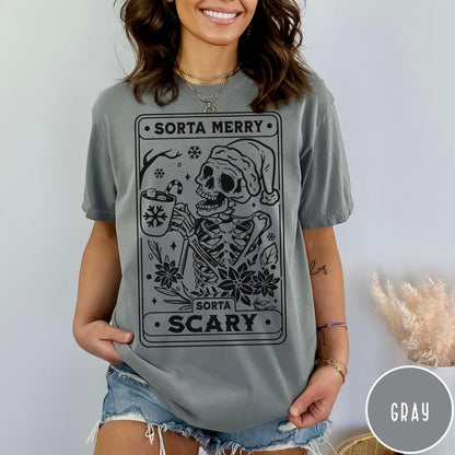 Comfort Colors tee in Gray featuring graphic illustration of a skeleton in a Santa hat holding cocoa