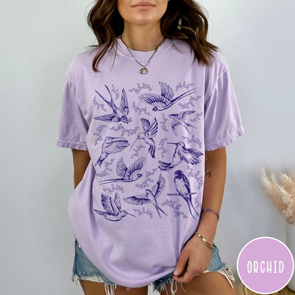 Comfort Colors tee in Orchid featuring vintage bird tattoo style graphic with various birds and flowers