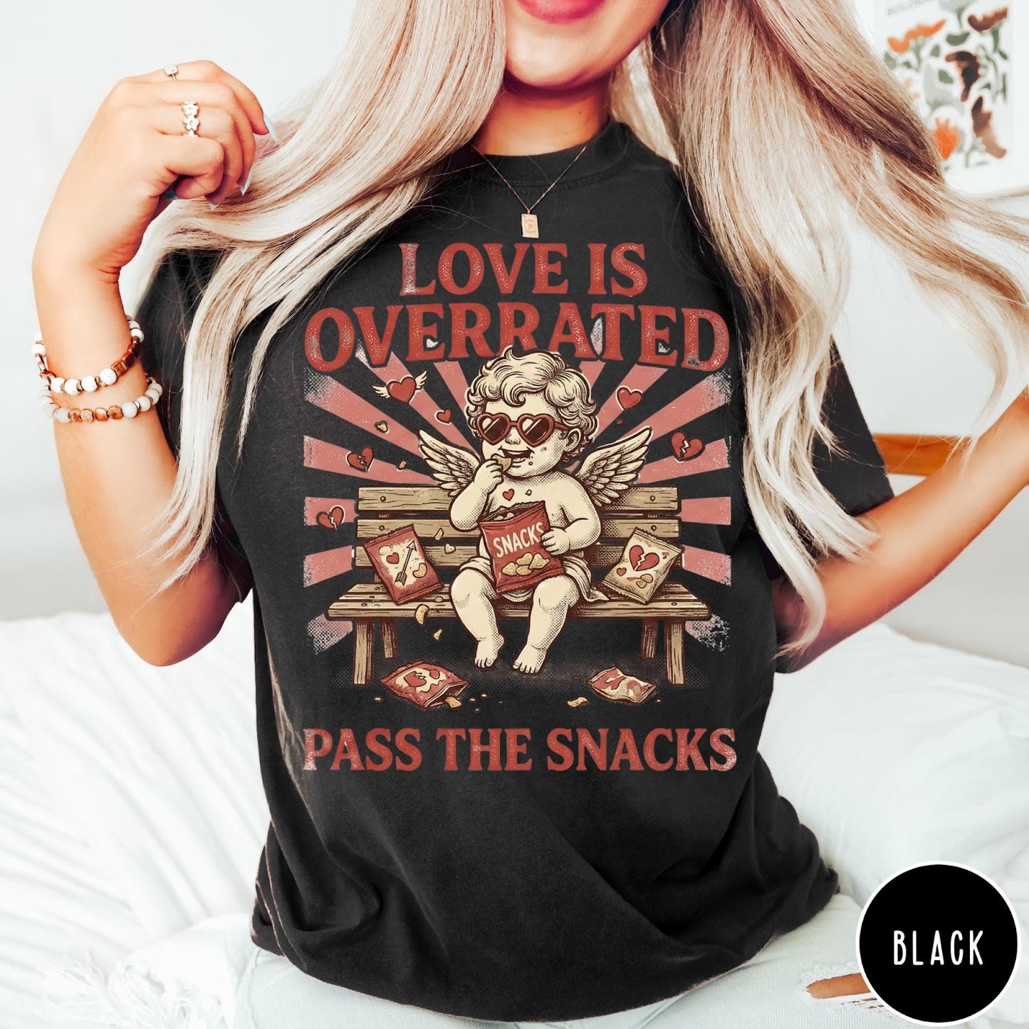 Comfort Colors tee in Black featuring vintage style graphic of a cherub eating snacks on a bench