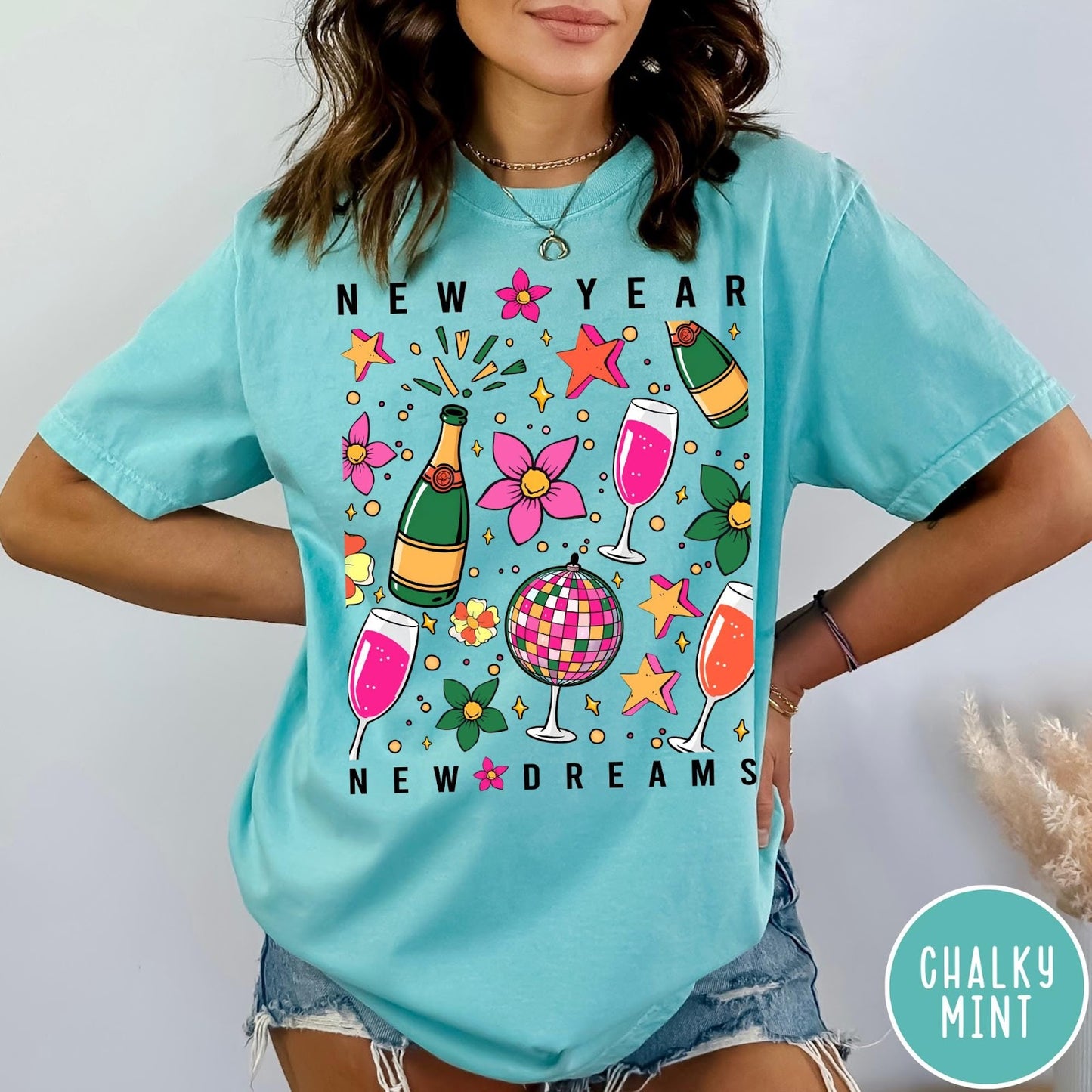 Comfort Colors tee in Chalky Mint featuring New Year celebration graphic with champagne bottles, glasses, and disco ball