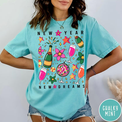 Comfort Colors tee in Chalky Mint featuring New Year celebration graphic with champagne bottles, glasses, and disco ball