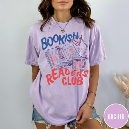Comfort Colors tee in Orchid featuring illustrated book graphic with a lamp and a coffee mug design