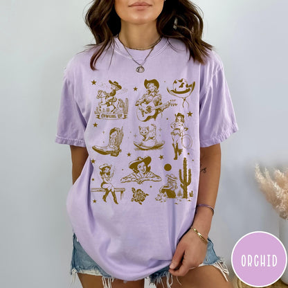 Comfort Colors tee in Orchid featuring retro western collage graphic with cowgirls, boots, and desert elements