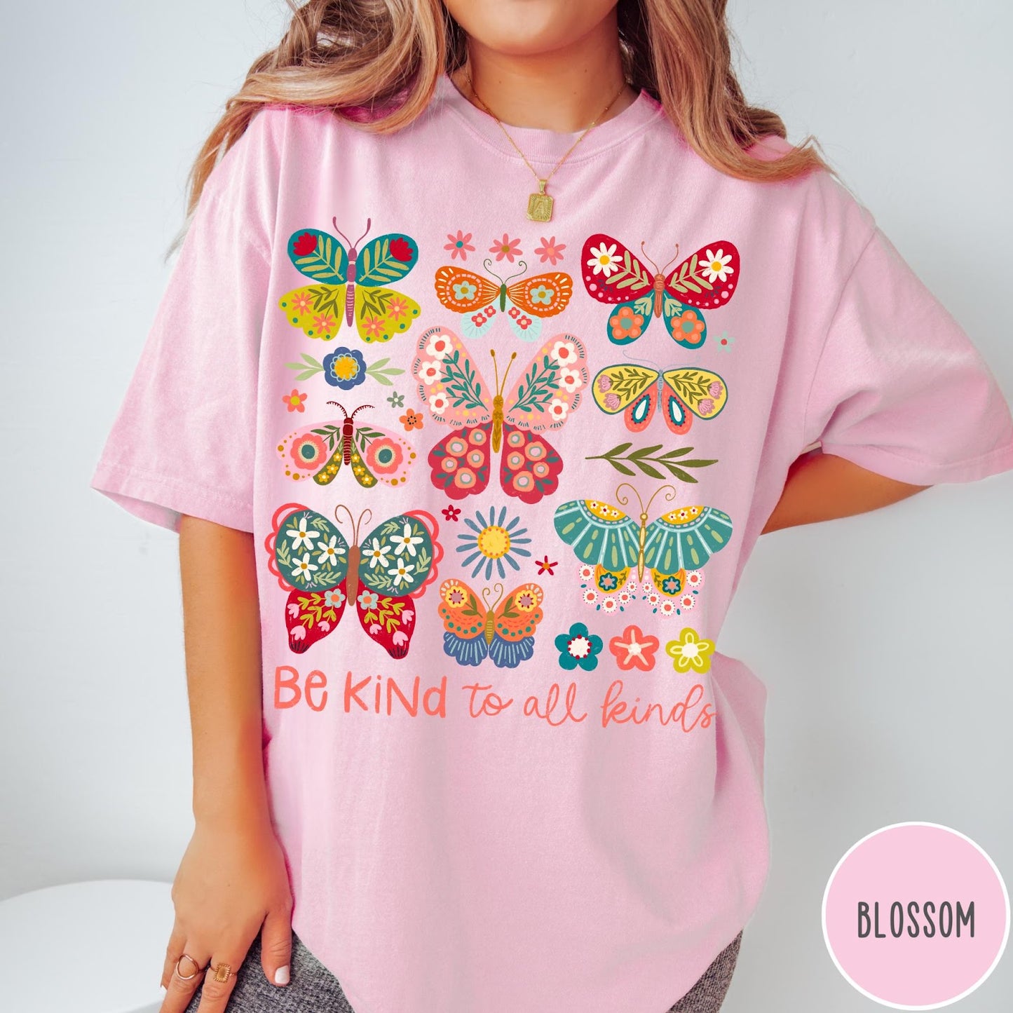 Comfort Colors tee in Blossom featuring butterfly and floral graphic design with Be Kind to all kinds text
