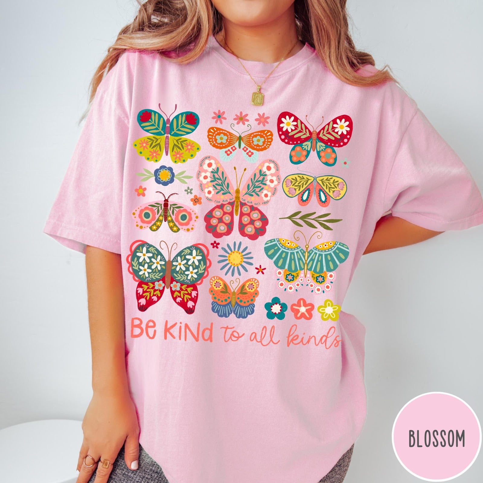 Comfort Colors tee in Blossom featuring butterfly and floral graphic design with Be Kind to all kinds text