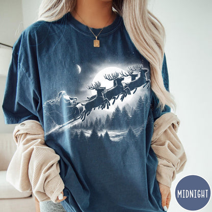 Comfort Colors tee in Midnight featuring vintage style Santa Claus flying in a sleigh with reindeer