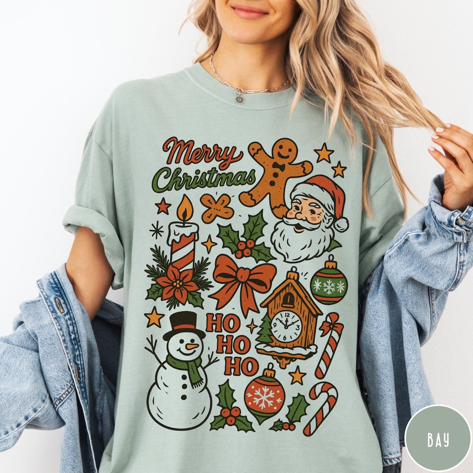 Comfort Colors tee in Bay featuring retro holiday design with Christmas icons like Santa and a snowman
