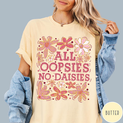 Comfort Colors tee in Butter featuring floral design with funny quote All Oopsies No Daisies text graphic