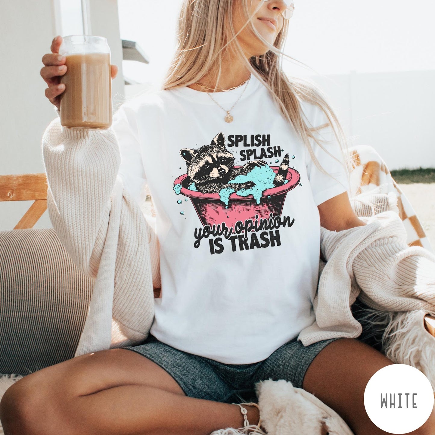 Comfort Colors tee in White featuring illustrative graphic of a raccoon sitting in a pink bathtub