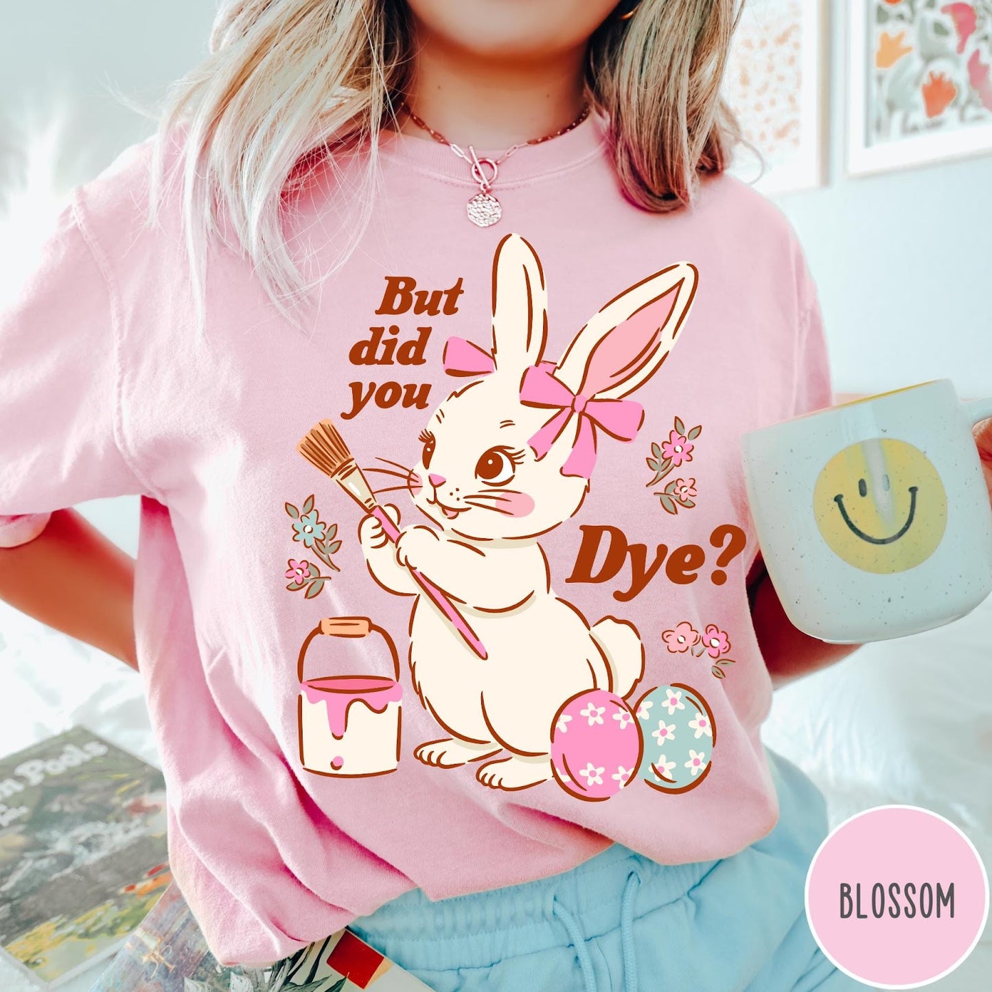 Comfort Colors tee in Blossom featuring cute Easter bunny graphic with paintbrush and painted Easter eggs.
